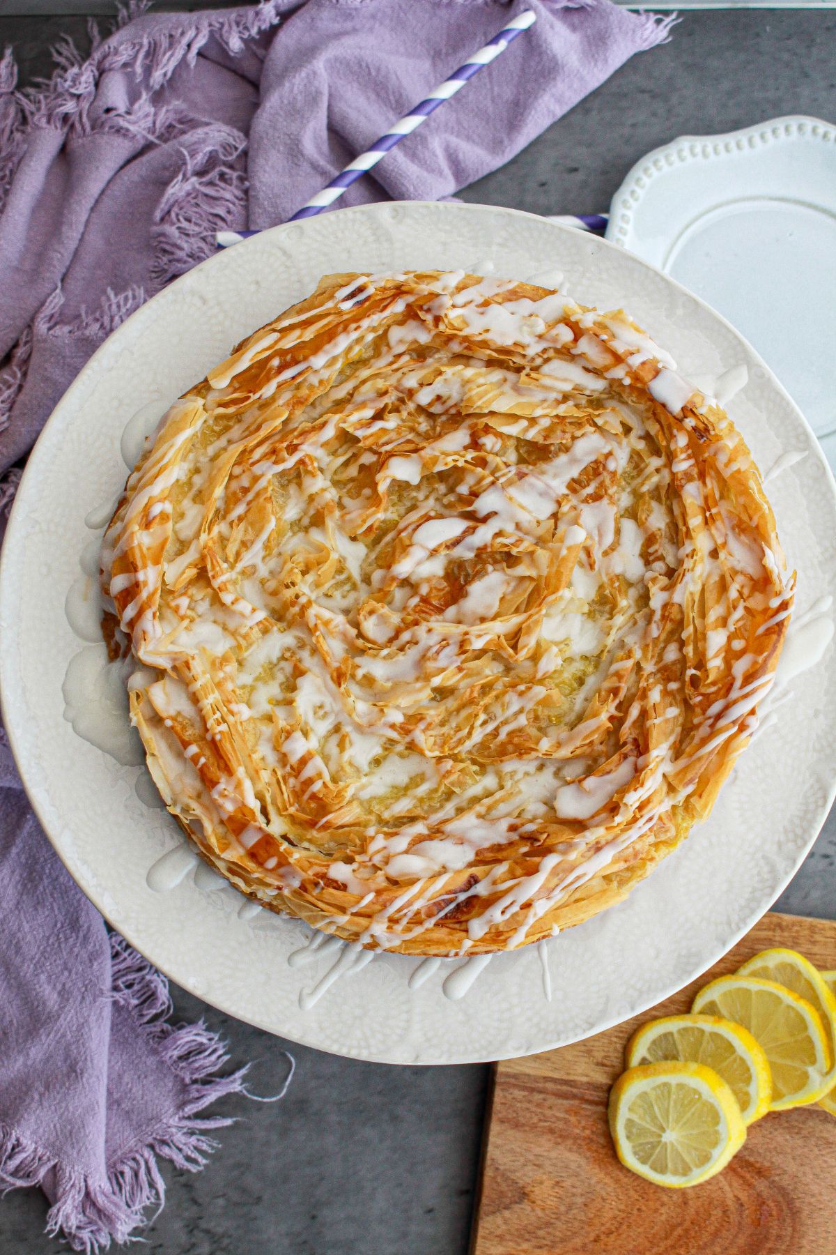 uncut lemon crinkle cake on a large plate.