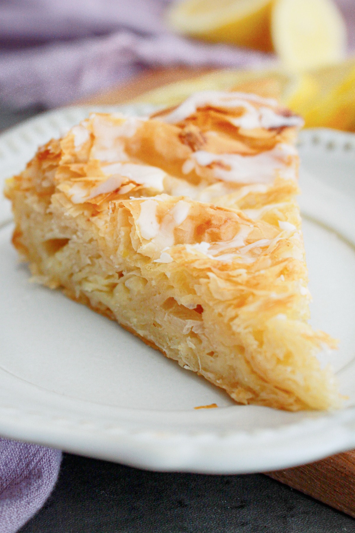 slice of lemon crinkle cake on a small plate.