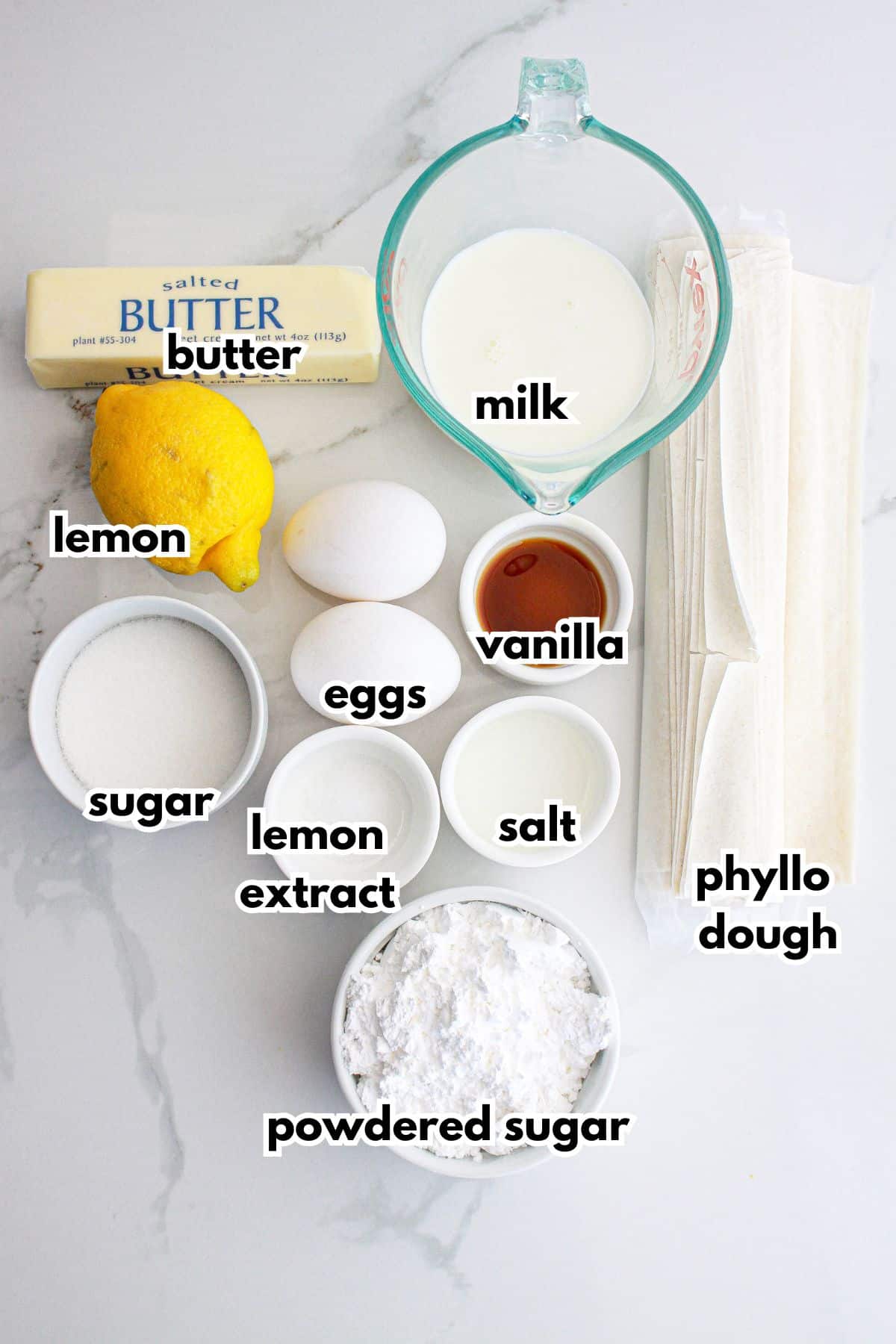 bowls of butter, lemon, sugar, eggs, lemon extract, salt, powdered sugar, milk, salt, and phyllo dough.