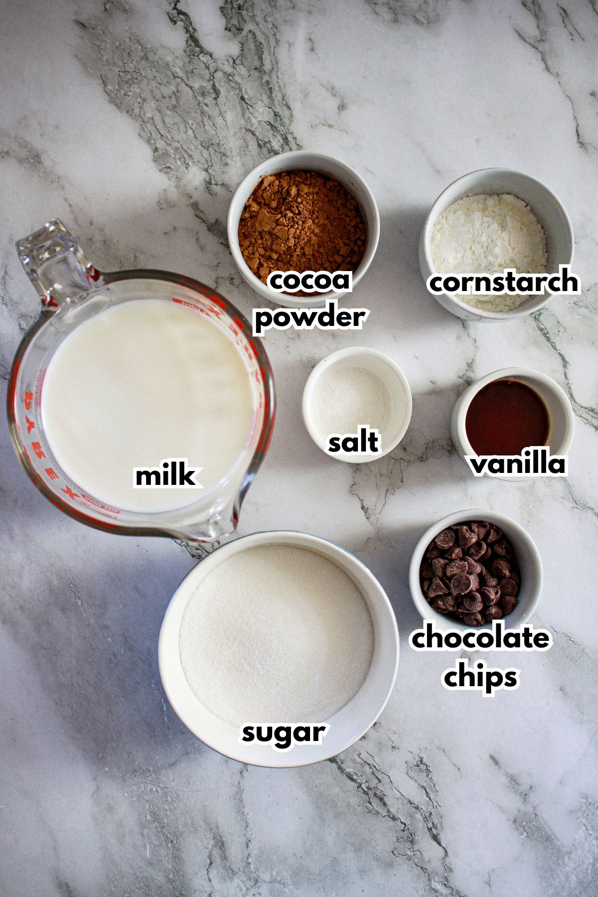 bowls of ingredients needed to chocolate pudding layer for a dessert.
