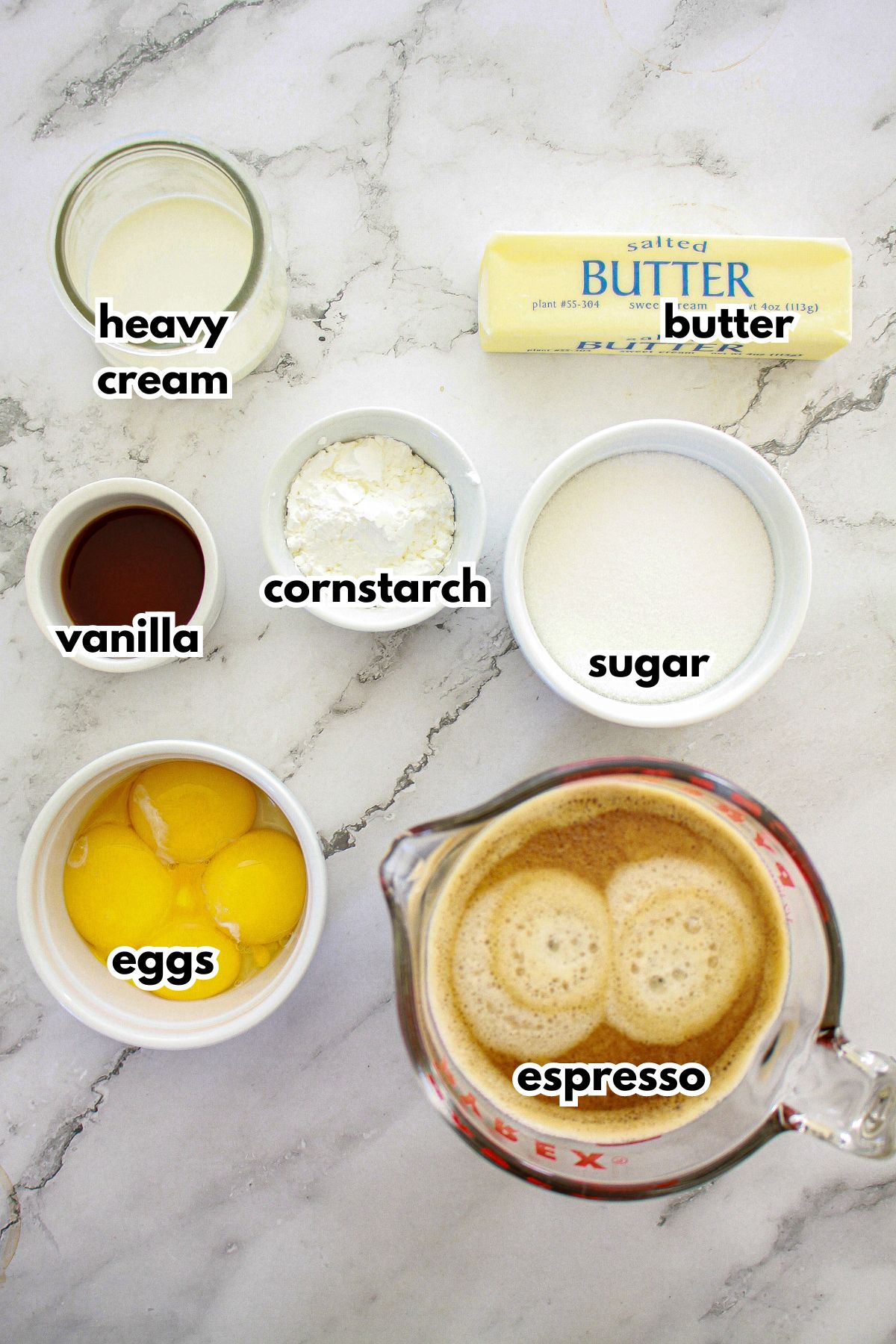 bowls of ingredients needed to a coffee pudding layer for a dessert on a counter.