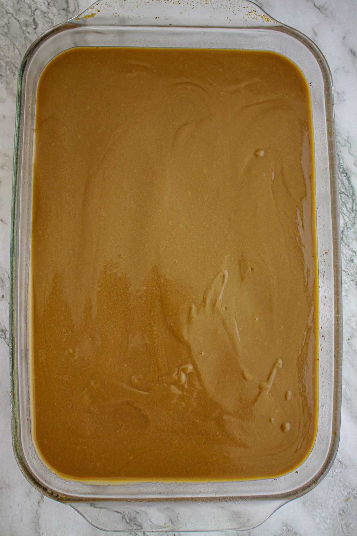 coffee layer being added to a baking dish.