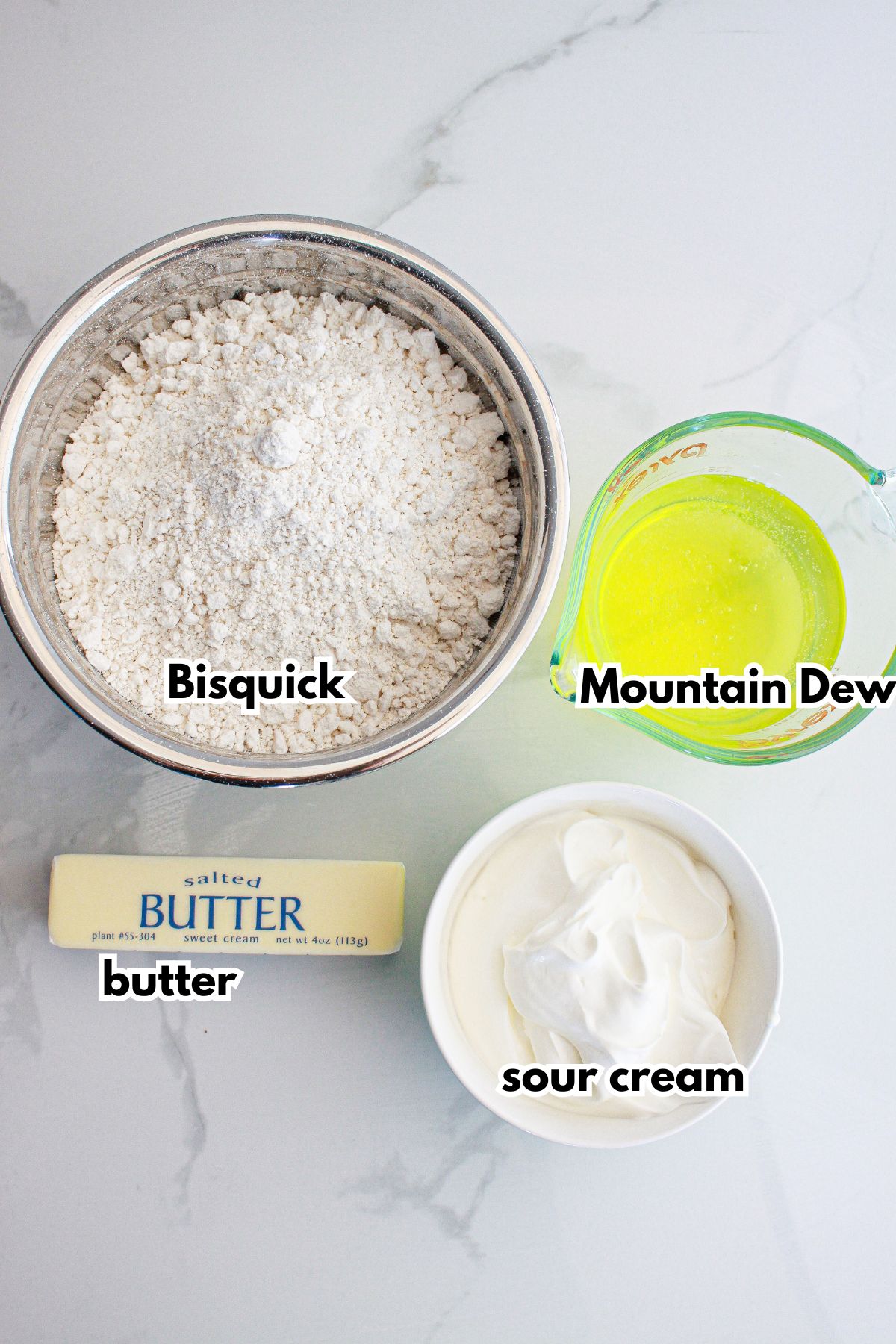 bowls of bisquick, butter, sour cream and mountain dew on a counter.