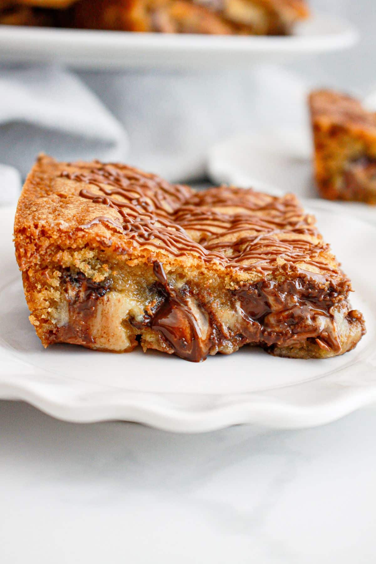 slice of peanut butter cup cookie bars on a plate.
