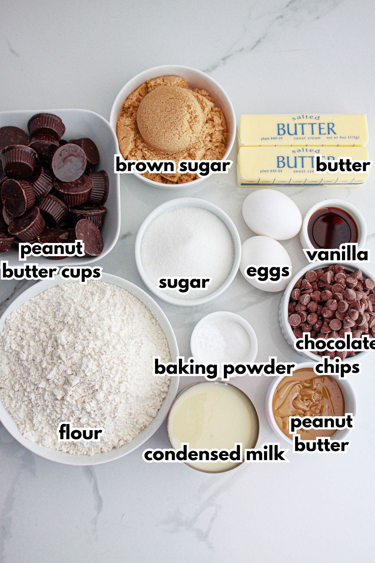 bowls of ingredients needed to make peanut butter cup cookies bars on a counter.