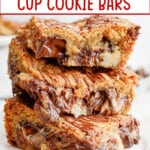 three peanut butter cup cookie bars stacked on a plate.
