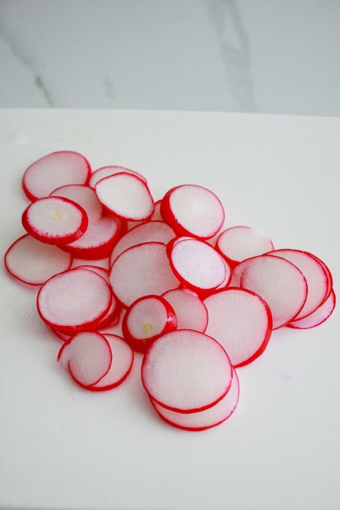 sliced radishes on a cutting board.