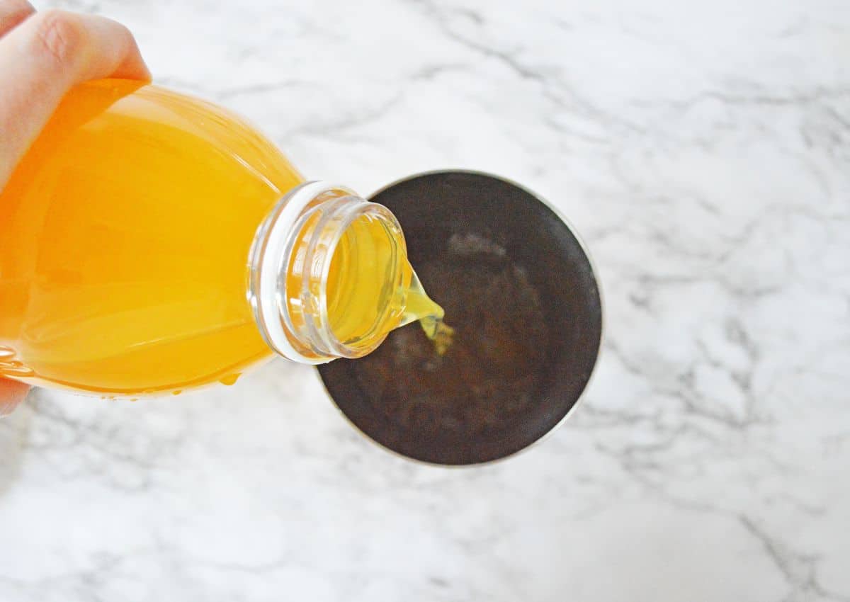 mango juice being added to the cocktail shaker.