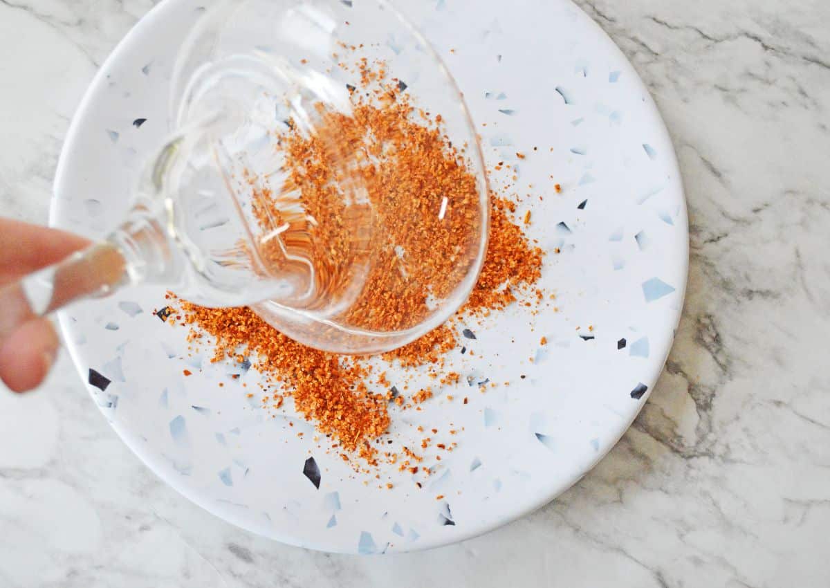 glass being rimmed in tajin seasoning.