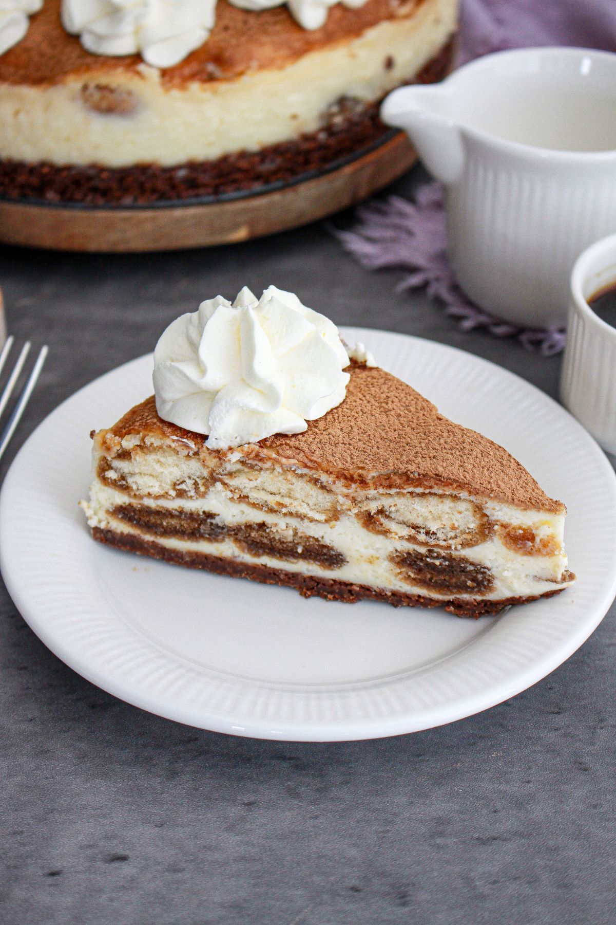 slice of tiramisu cheesecake on a small plate.