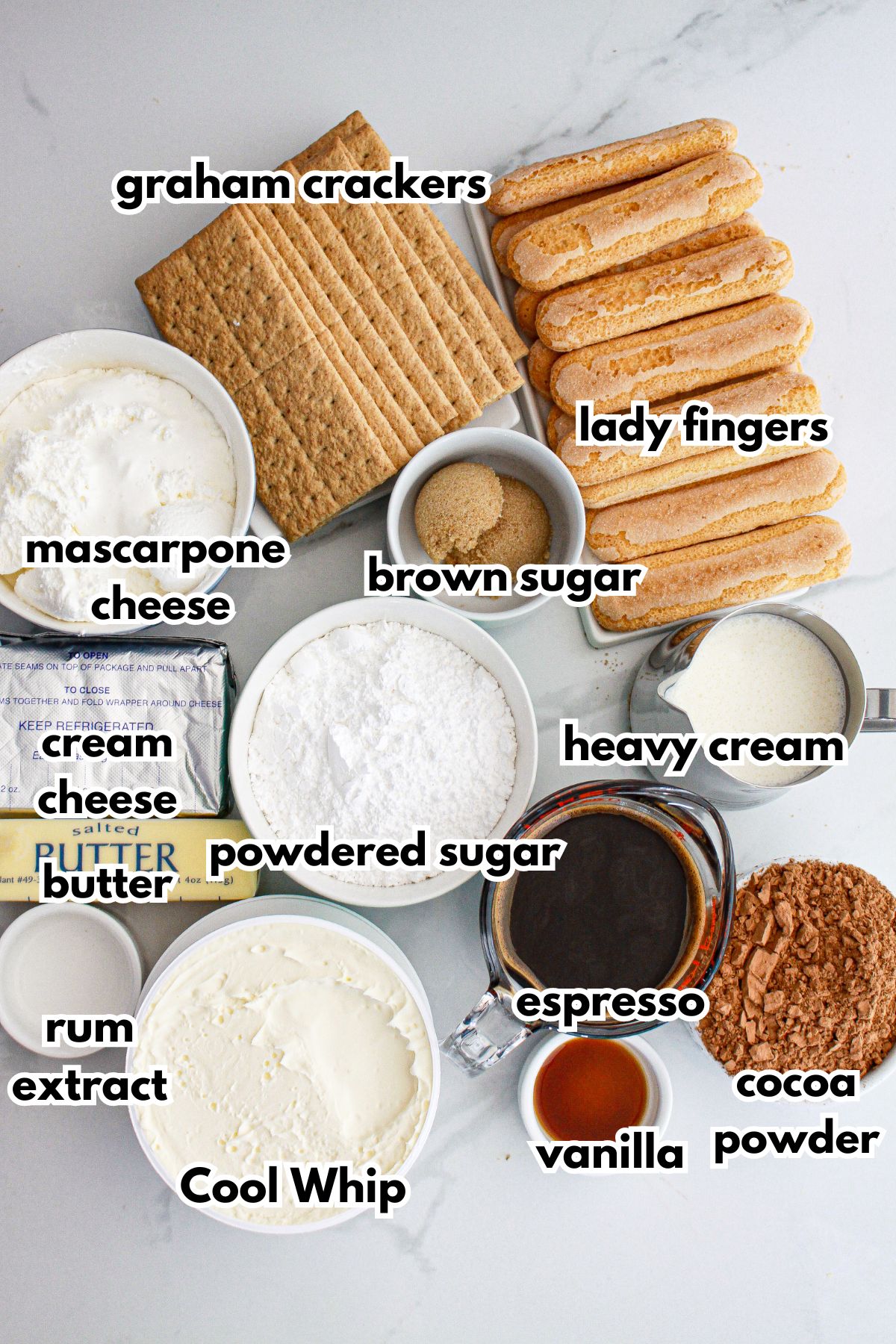 bowls of ingredients needed to make tiramisu cheesecake on a counter.