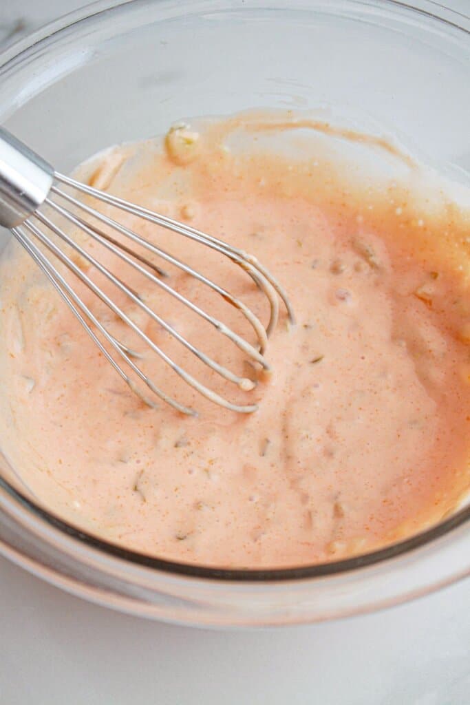 special sauce being whisked in a glass bowl.