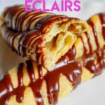 two cappuccino eclairs on a plate with one broken in half.