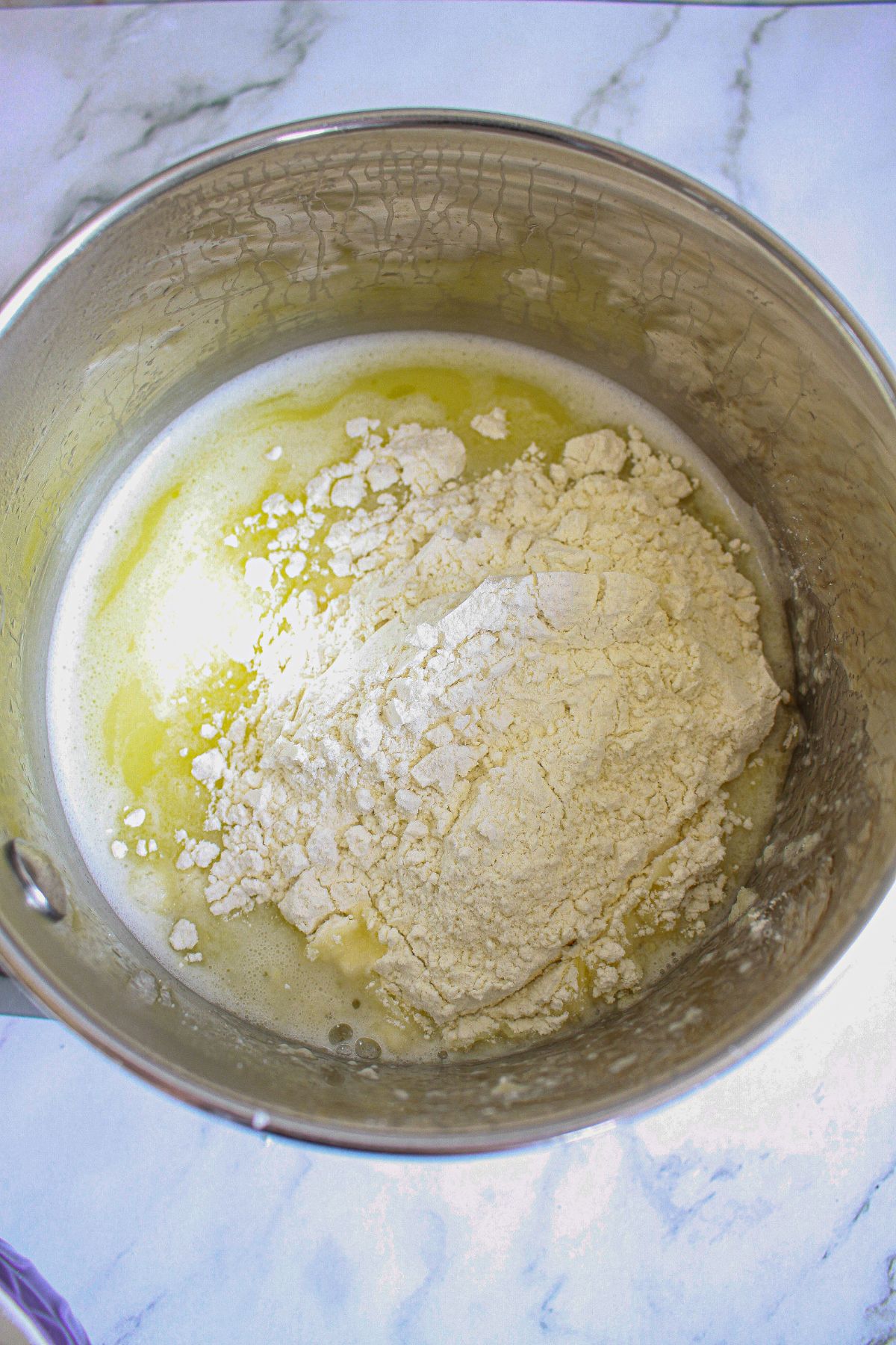 flour being added to melted butter in a saucepan.