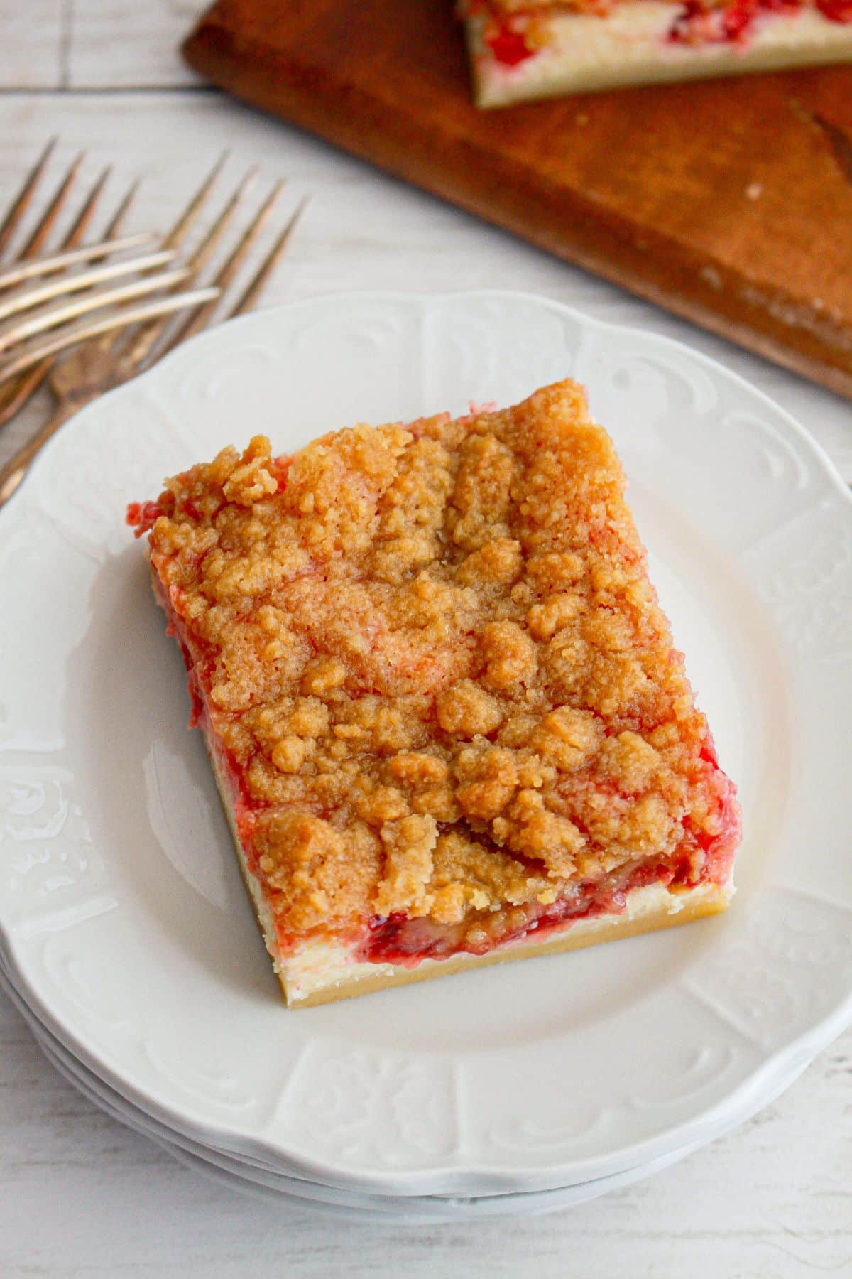 slice of cherry pie cheesecake bar on a plate.