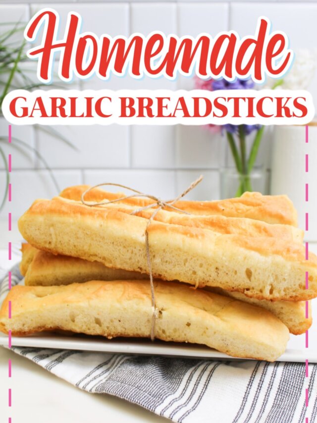 homemade garlic breadsticks on a plate.