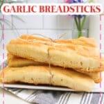 homemade garlic breadsticks on a plate.