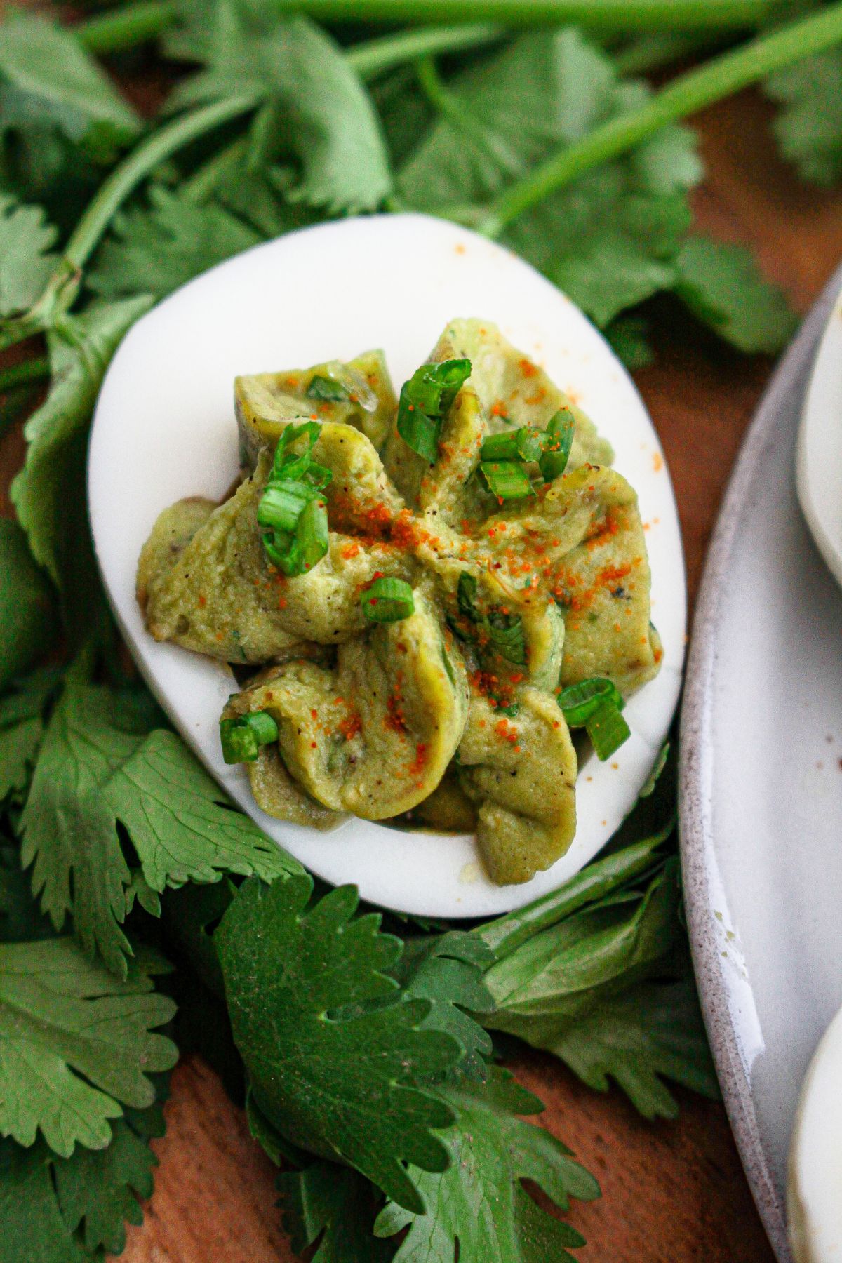 gulacmole deviled egg on a bed of cilantro.