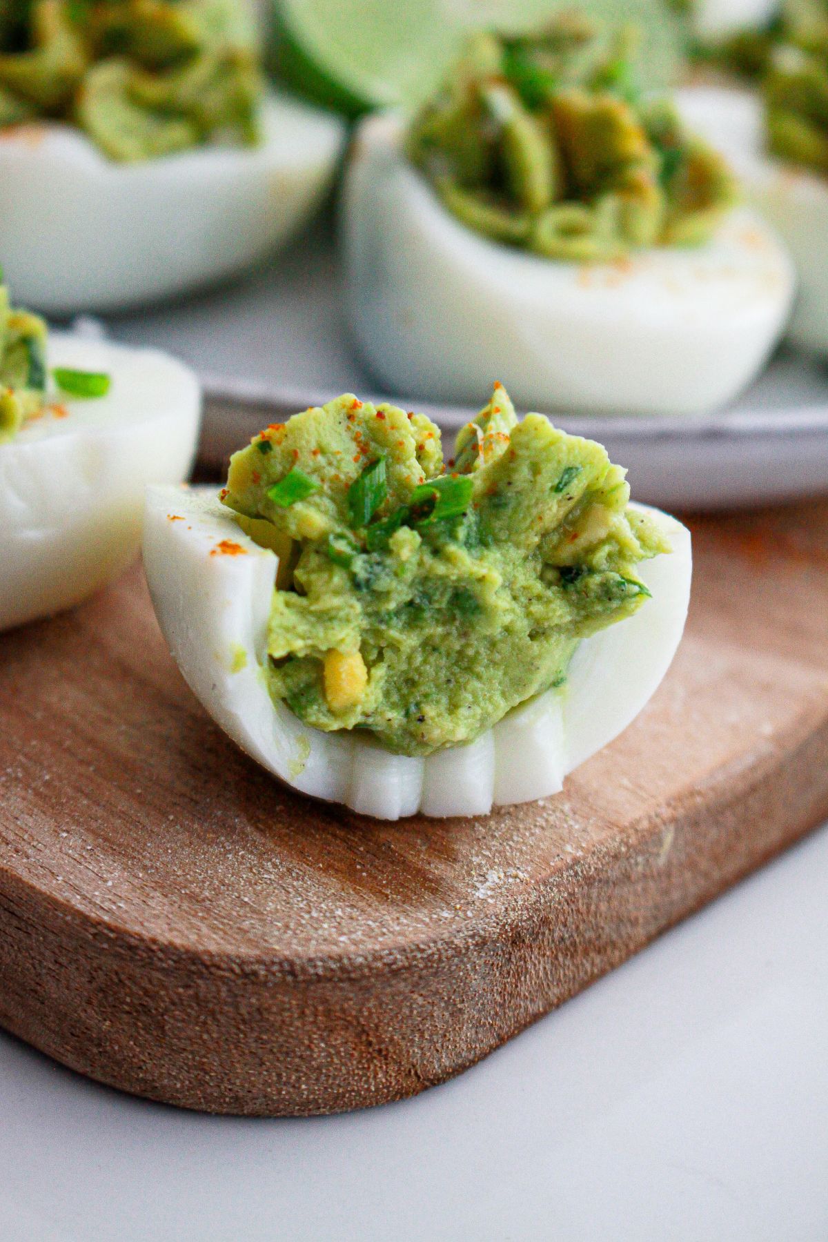 guacamole deviled eggs biten in half.