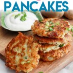 five hash brown pancakes stacked on a wooden cutting board.