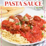 plate full of homemade pasta sauce on top of a plate of spaghetti noodles.