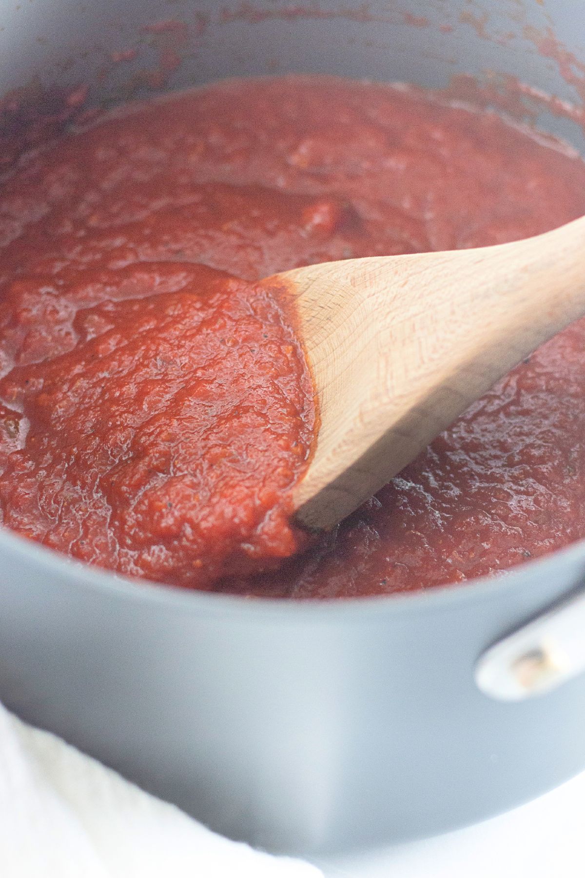 homemade pizza sauce simmering in a large pot.