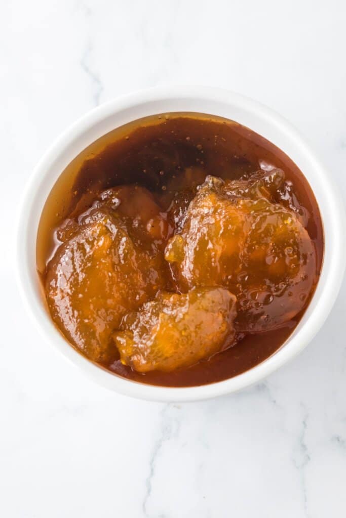 peach bbq sauce being mixed in small bowl.