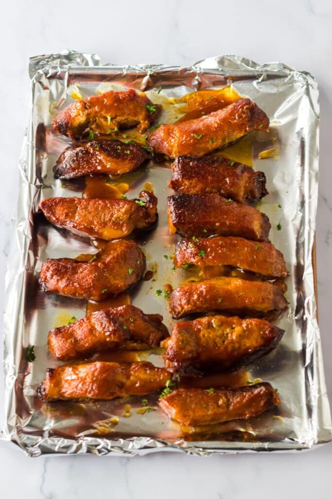 caramelized ribs on a foil lined baking sheet.