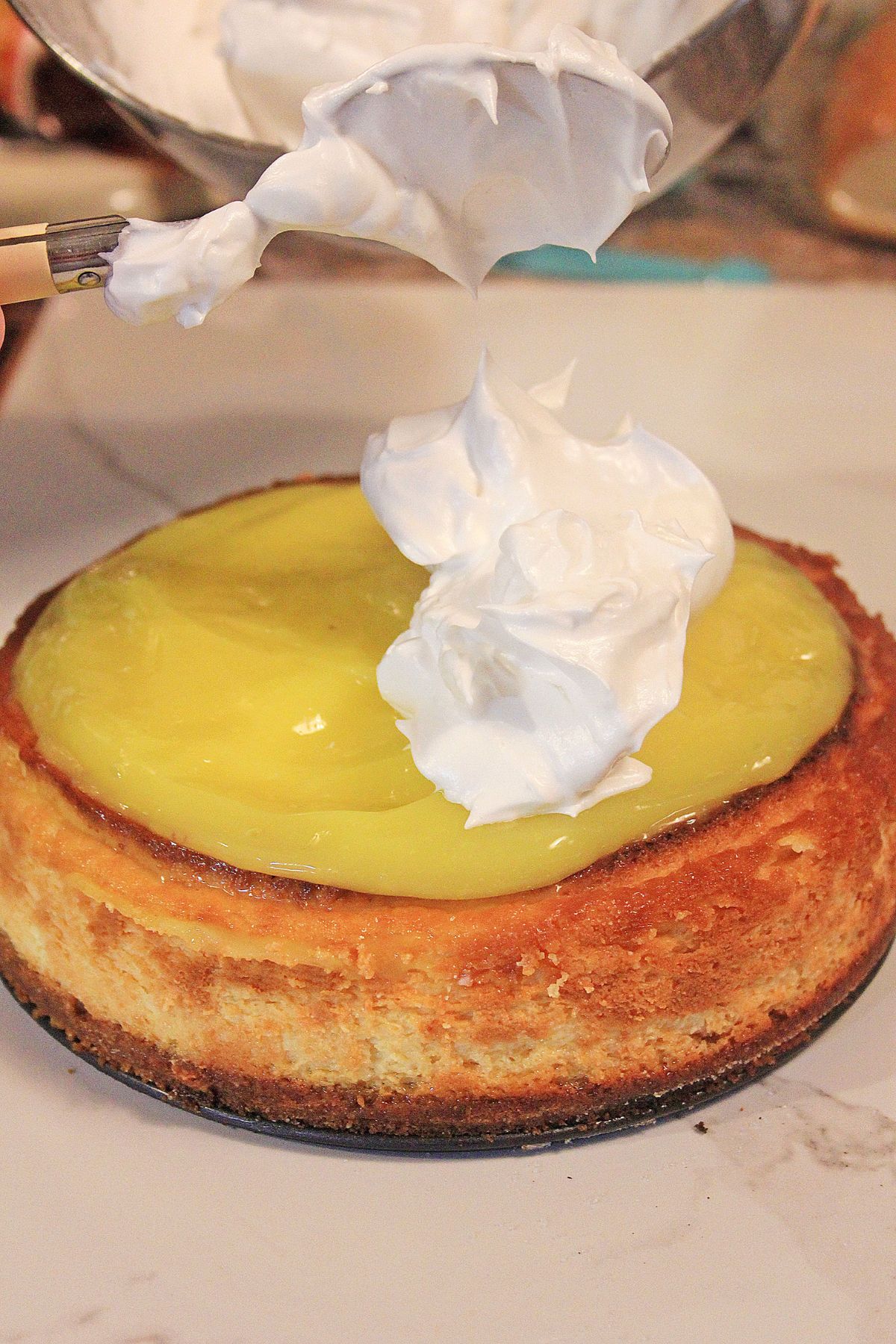 egg whites being added to the top of the cake.