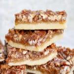 pecan shortbread cookies stacked on a plate.