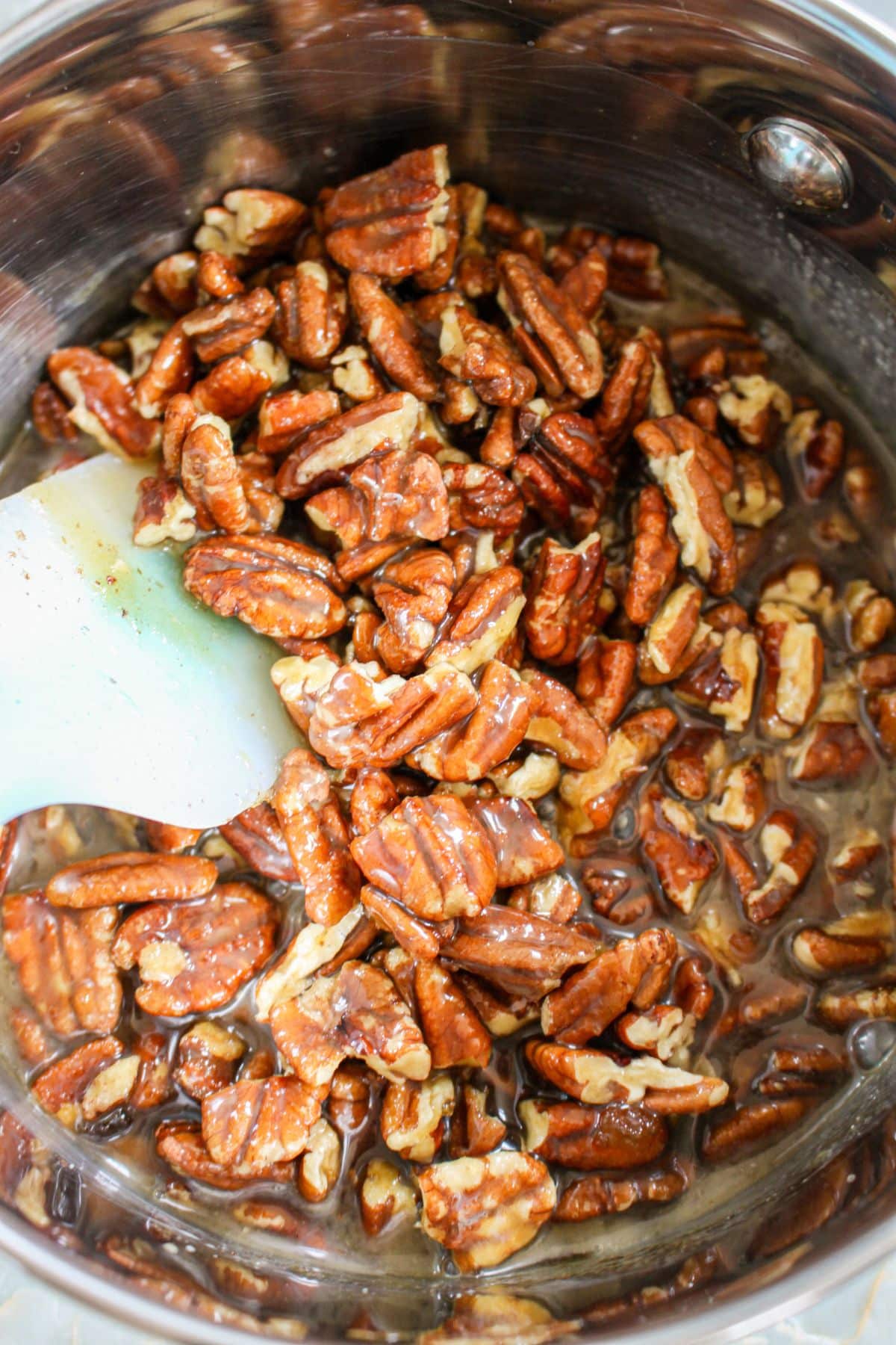 pecans being cooked in a saucepan.