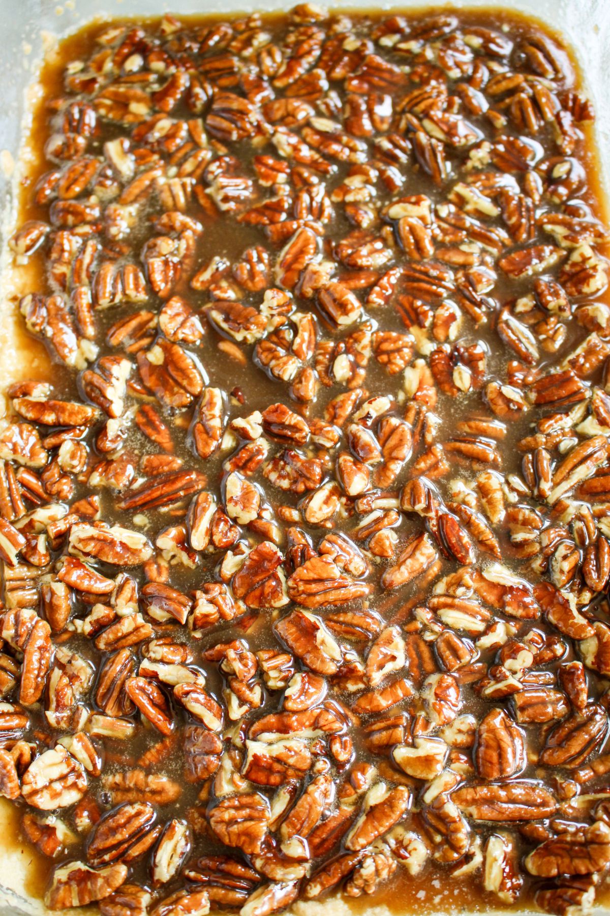 pecan topping being spread on top of crust.