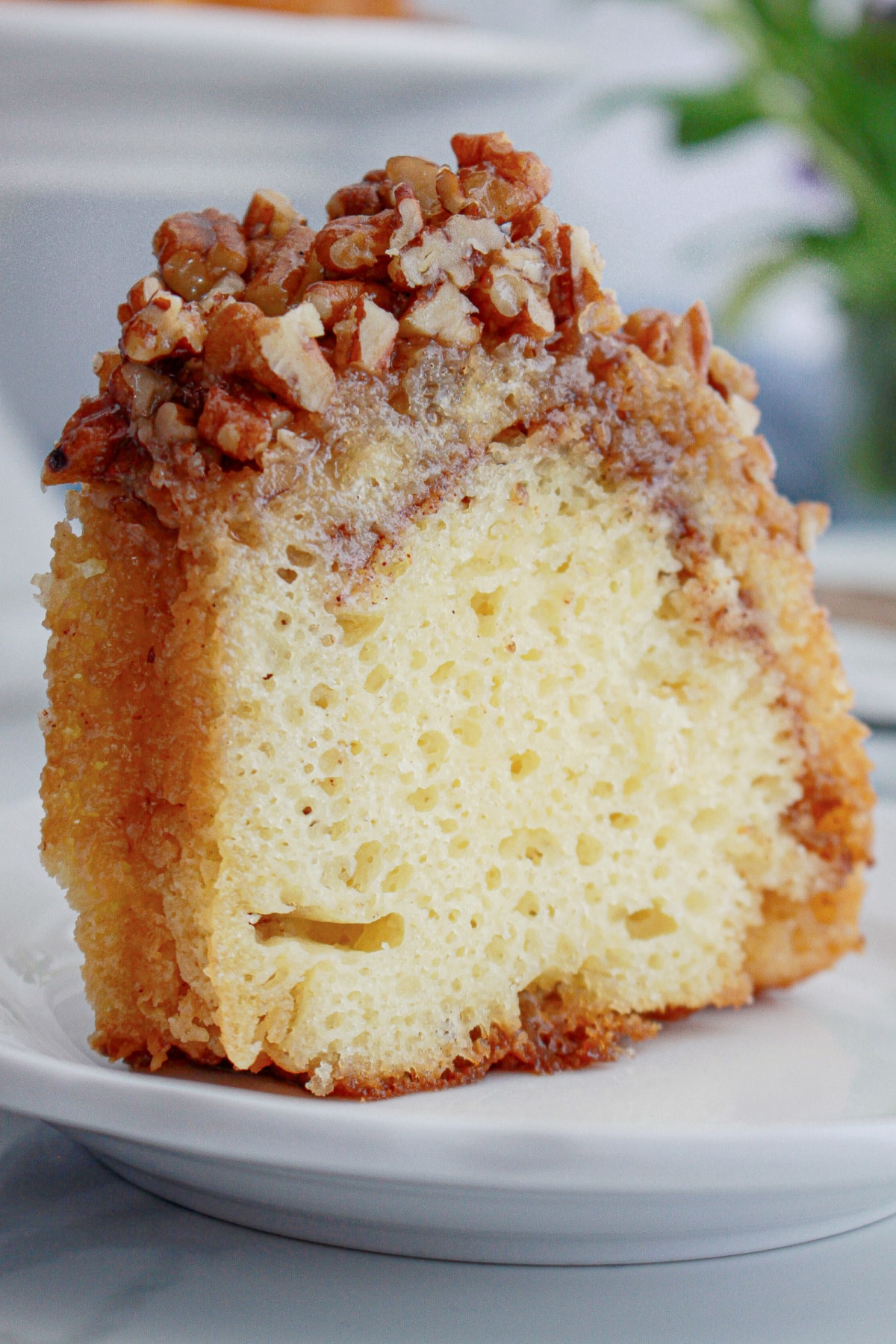 slice of pecan upside down cake on a small plate.
