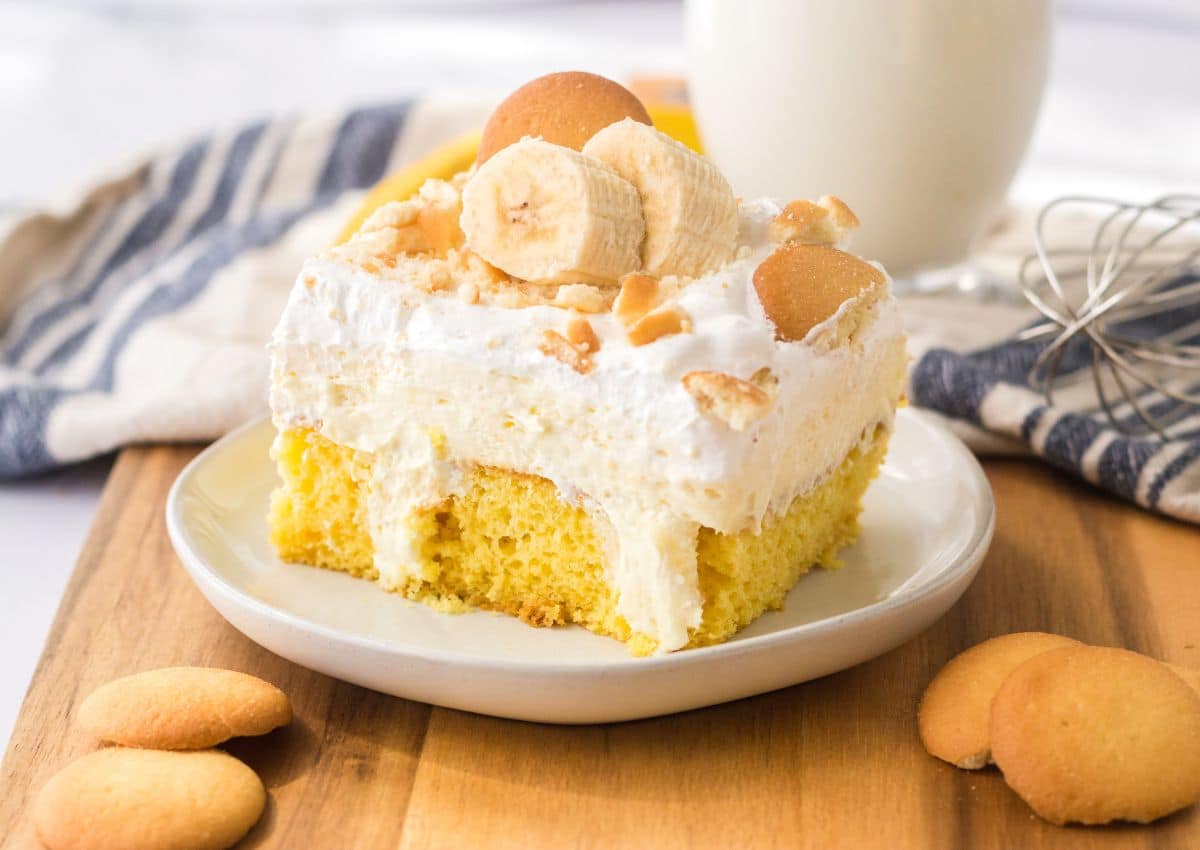 slice of banana poke cake on a small plate.