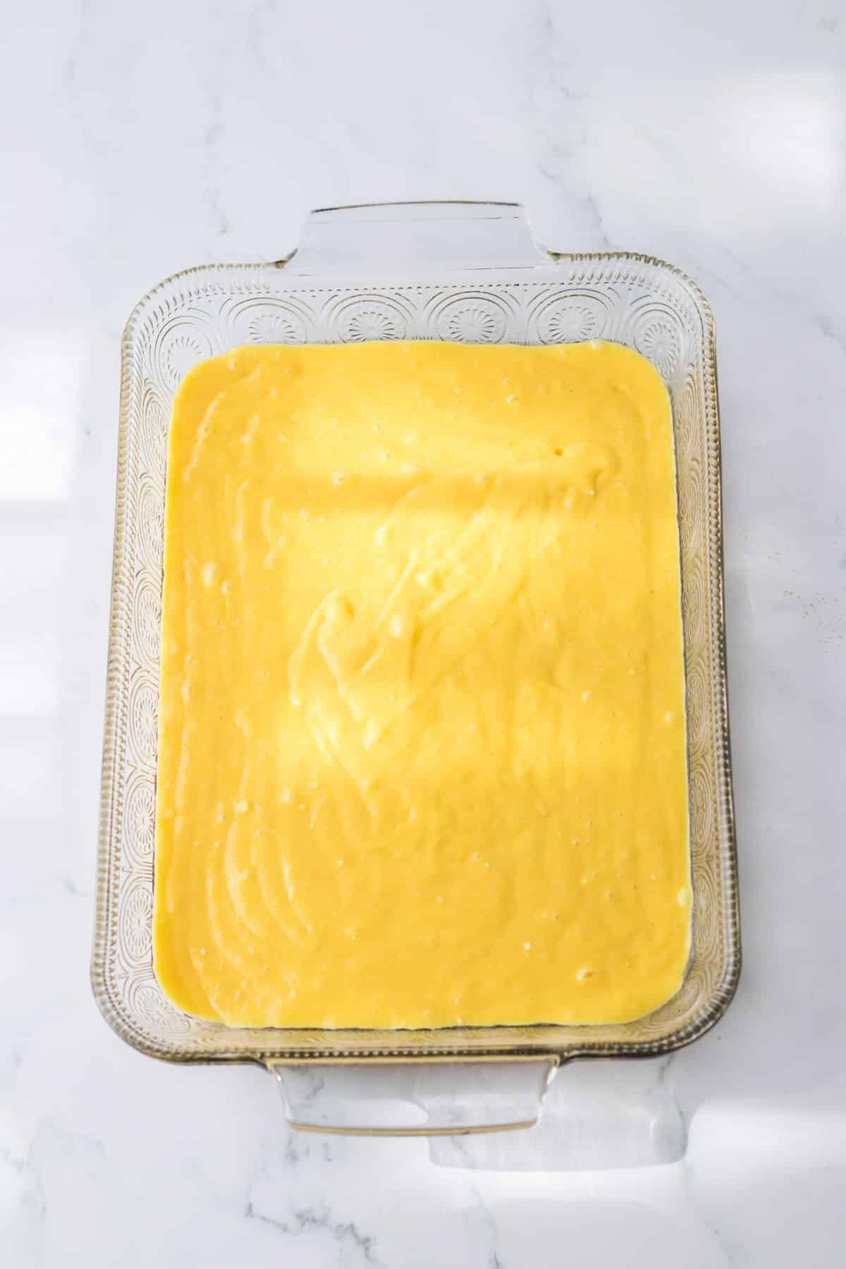 cake batter in a glass baking dish.