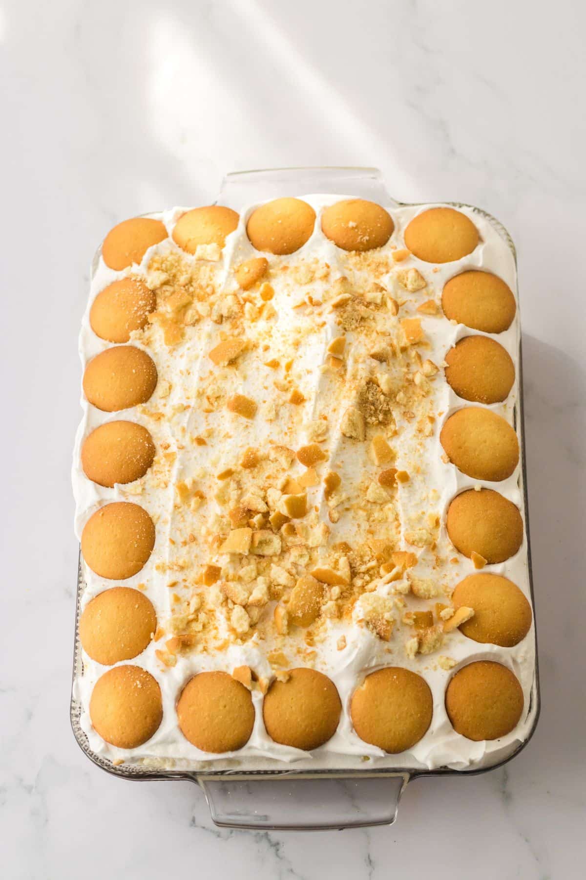 uncut banana pudding poke cake in a glass baking dish.