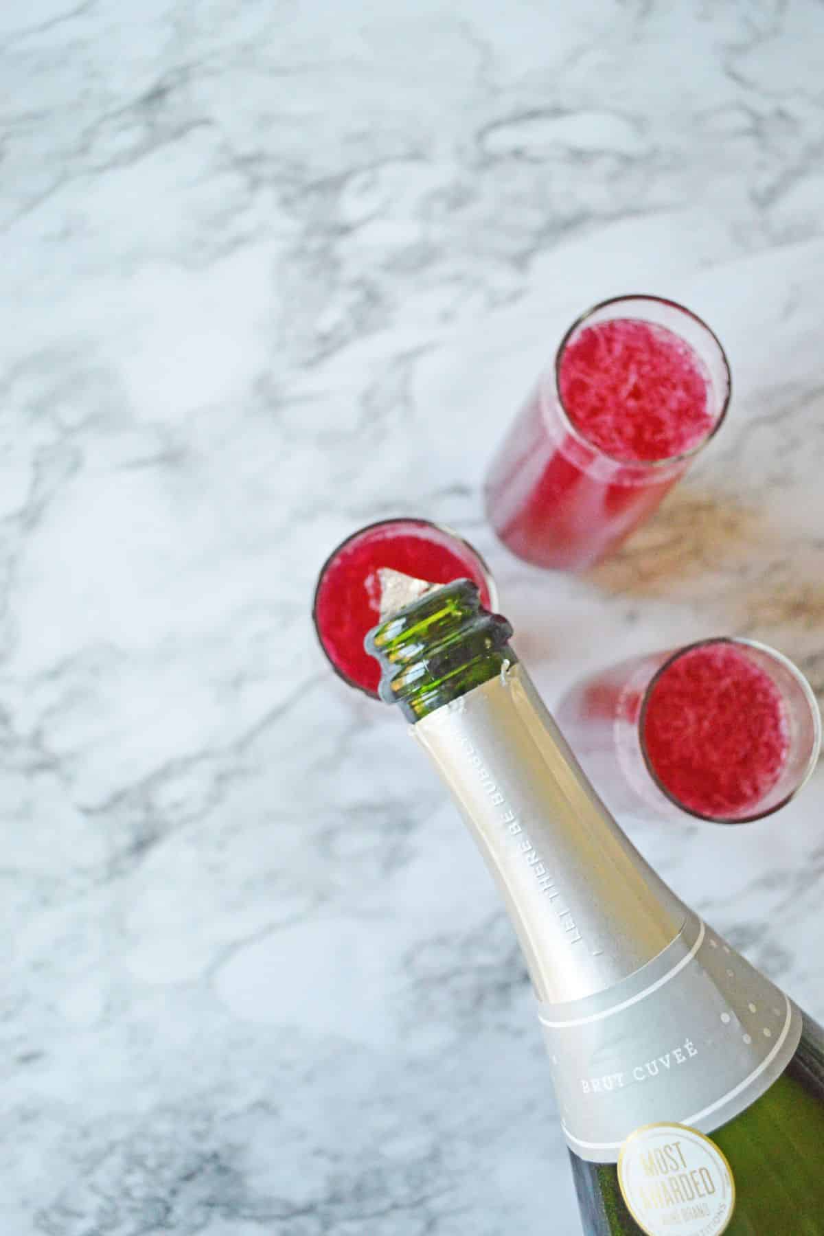 champagne being poured into a cocktail glass.