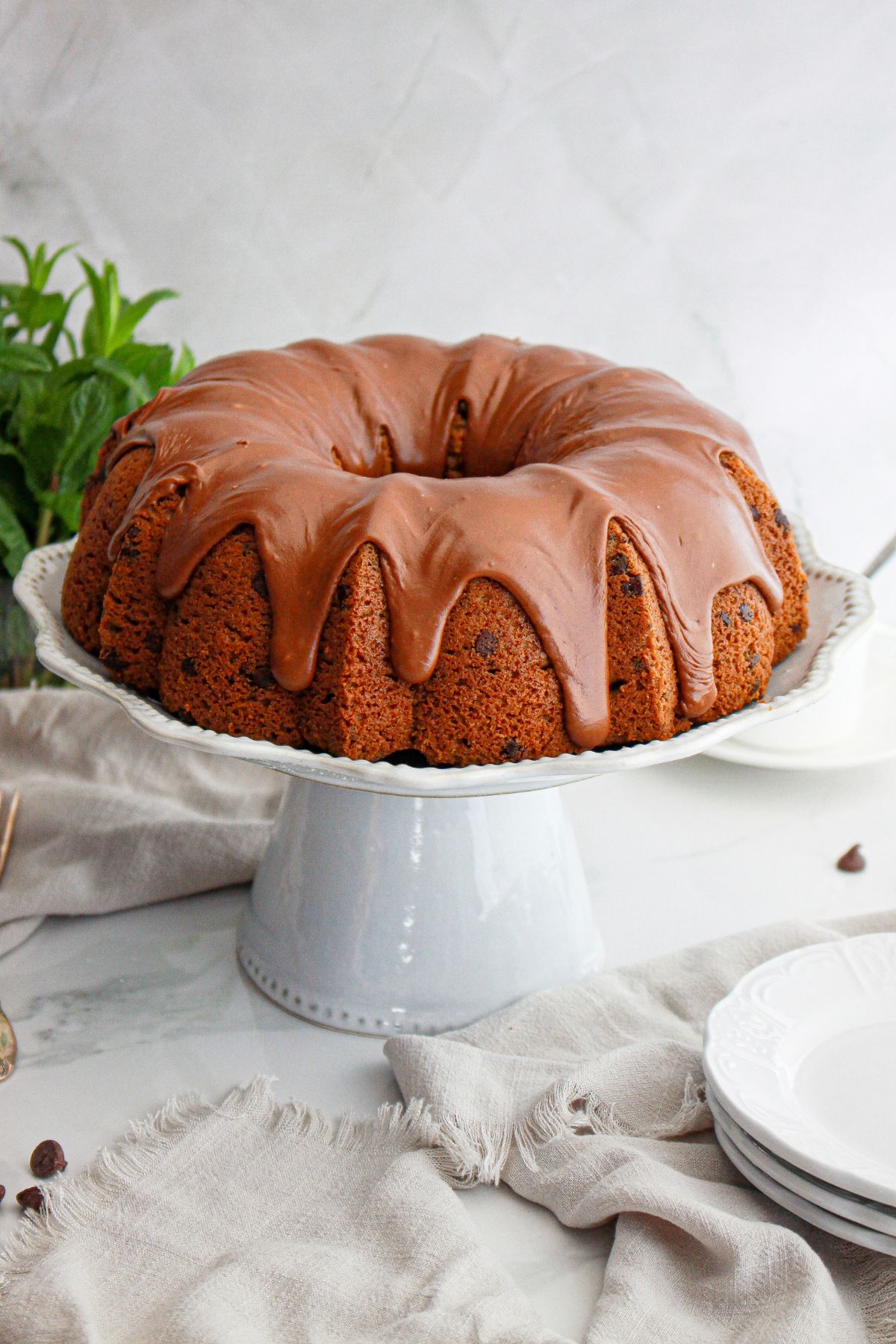 uncut chocolate espresso bundt cake on a cake stand.
