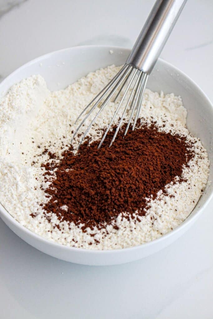 flour, espresso, powder bieng mixed in a bowl.