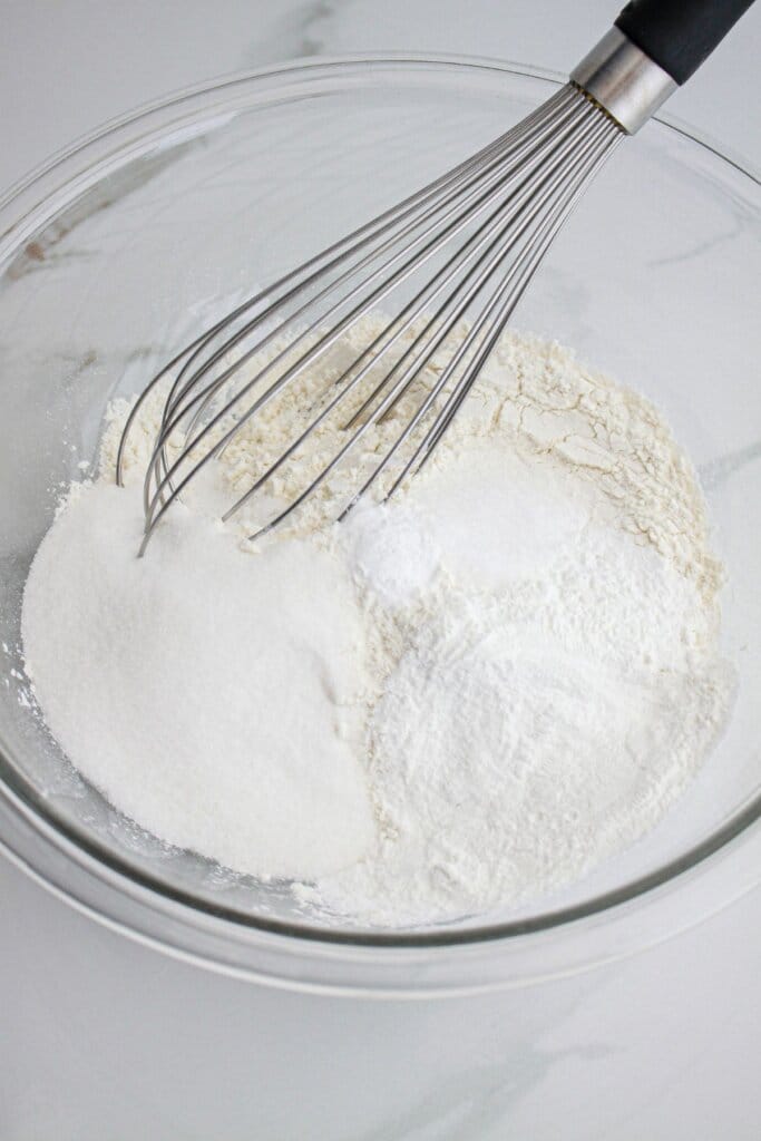 dry ingredients being whisked in a large bowl.