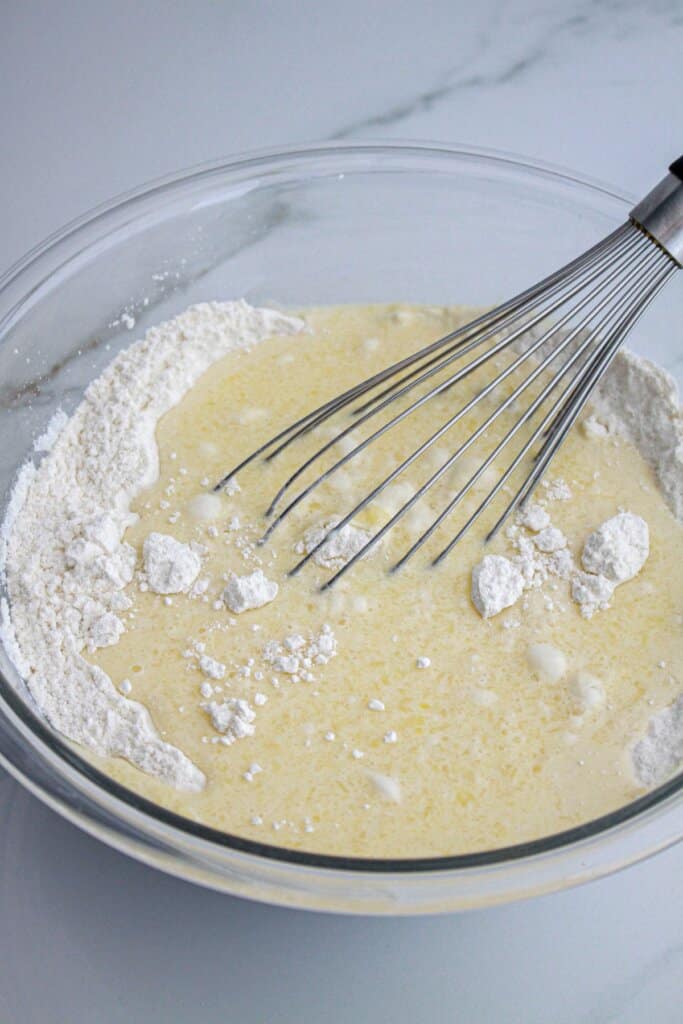 wet and dry ingredients being added to make batter.