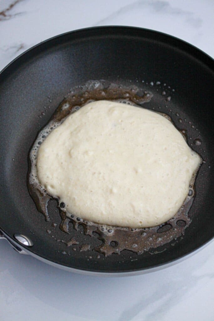 pancake being cooked in a skillet.