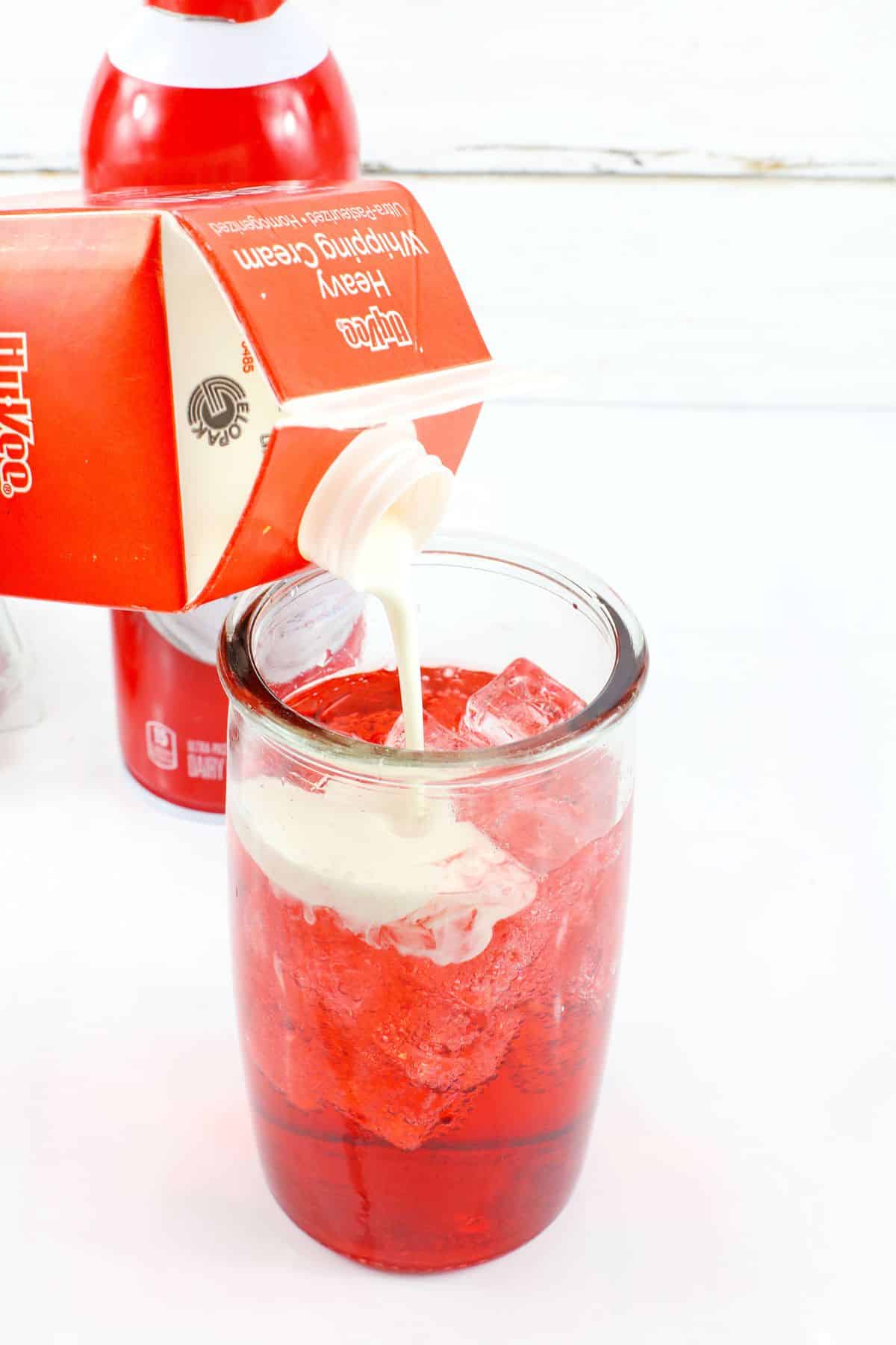 heavy cream being poured into a glass.