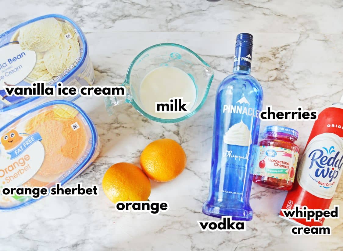 containers of vanilla ice cream, orange sherbet, oranges, milk, vokda, cherries and reddi whip on a counter.