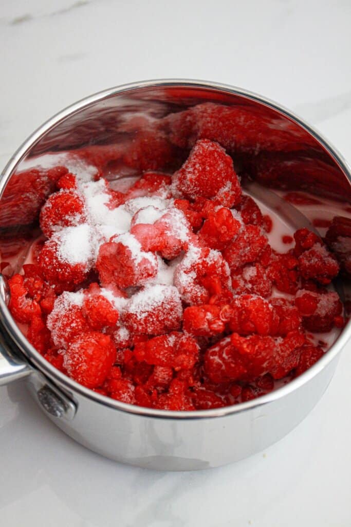 raspberries and sugar in a saucepan.