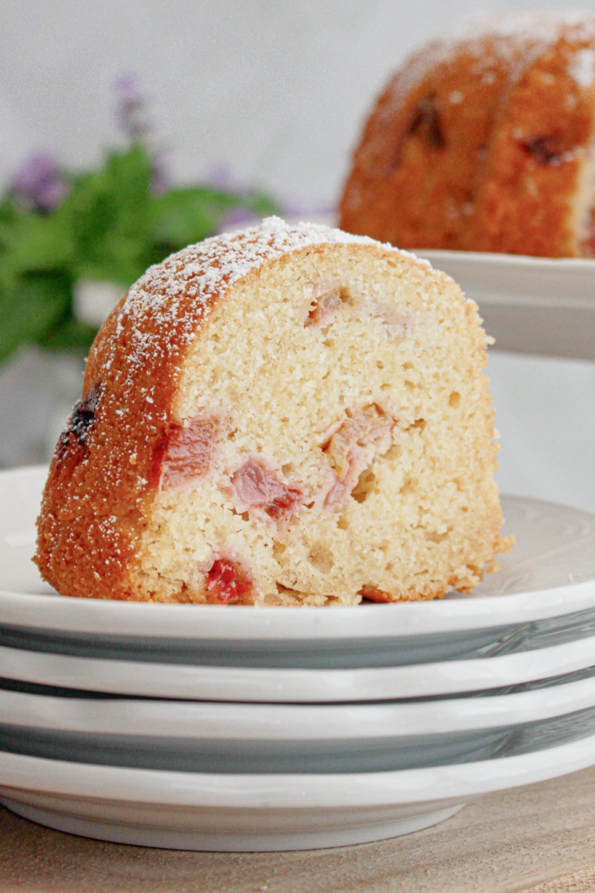 slice of rhubarb strawberry bundt cake on a small plate.