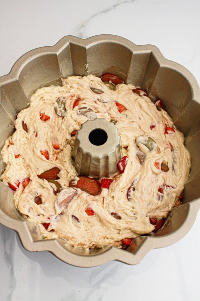 batter being spread into a pound cake pan.