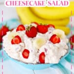 bowl full of strawberry banana cheesecake salad and topped with sliced strawberries.