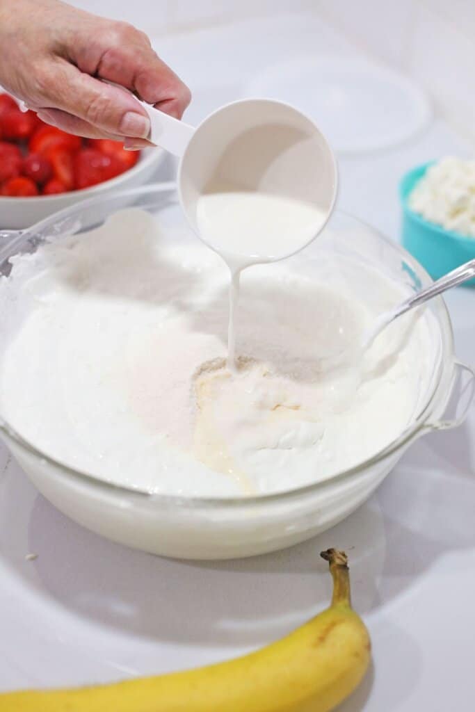 vanilla cream being mixed with pudding.