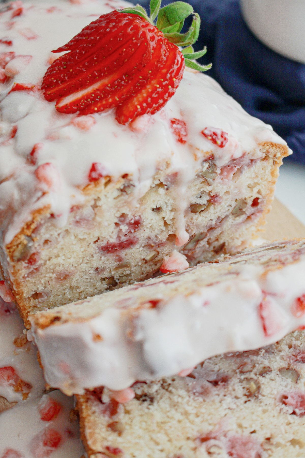 slices of strawberry bread being cut off a loaf.